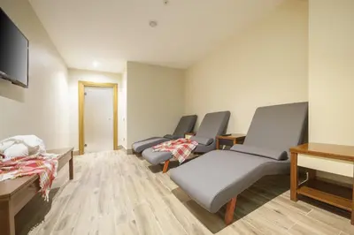 a hospital room with three chairs and a television at Lamec Hotel Business in Gebze
