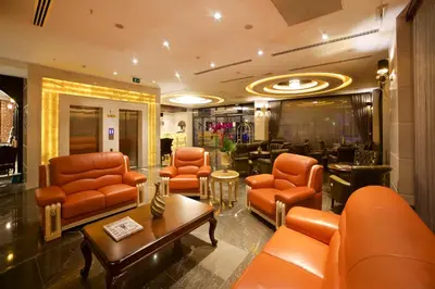 a lobby with orange leather chairs and a table at Icon Hotel Taksim in Istanbul