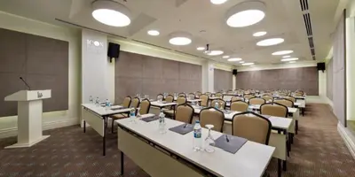 a conference room with tables and chairs and a podium at Icon Hotel Taksim in Istanbul