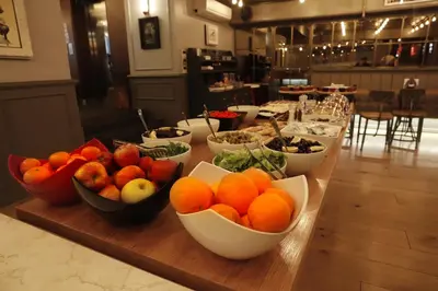 a table with bowls of fruits and vegetables on it at Bankerhan Hotel Galata - Adults Only Special Category in Istanbul