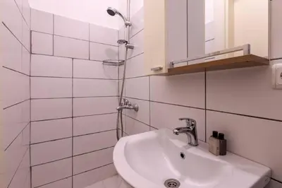 a white bathroom with a sink and a mirror at Luxury Modern 3Bed25Bath Central Bright Pad #375 in Istanbul