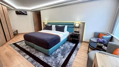 a bedroom with a bed and a couch and a chair at Vital Hotel Suites in Istanbul