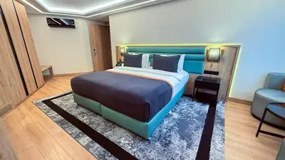a bedroom with a blue bed and a blue chair at Vital Hotel Suites in Istanbul