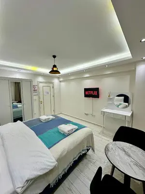 a bedroom with a bed and a sign that reads netflix at Öz Suit in Istanbul