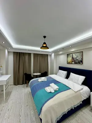 a bedroom with a large bed with two towels on it at Öz Suit in Istanbul