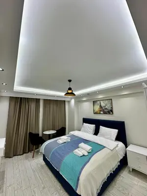 a bedroom with a large bed with towels on it at Öz Suit in Istanbul