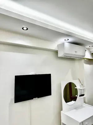a living room with a flat screen tv on a wall at Öz Suit in Istanbul
