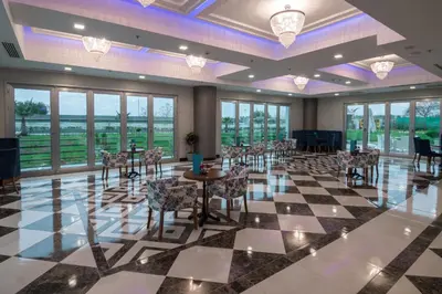 a large room with tables and chairs and windows at Elite Hotels Darica Spa & Convention Center in Gebze
