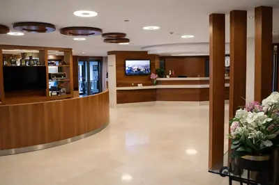 a lobby with a waiting room with flowers in the foreground at Riva Hotel Taksim in Istanbul