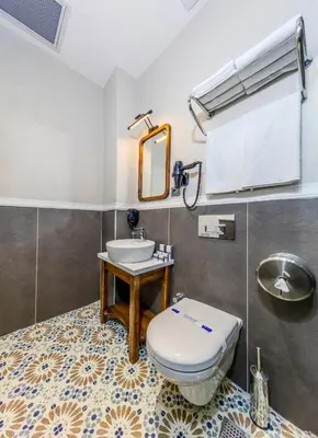 a bathroom with a toilet and a sink at Nenessa Airport Hotel in Arnavutköy
