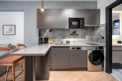 a kitchen with a sink and a dishwasher at Urban Quarters - Firuzağa in Istanbul