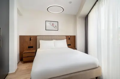 a bedroom with a white bed and a window at Urban Quarters - Firuzağa in Istanbul