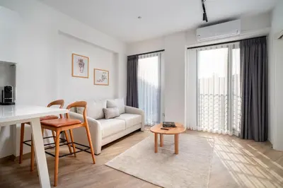 a living room with a white couch and a table at Urban Quarters - Firuzağa in Istanbul