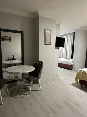 a room with a table and a bed and a mirror at Brave otel in Darıca