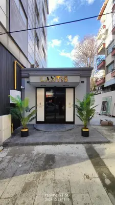 a building with two palm trees in front of it at Lantis Otel in Avcılar