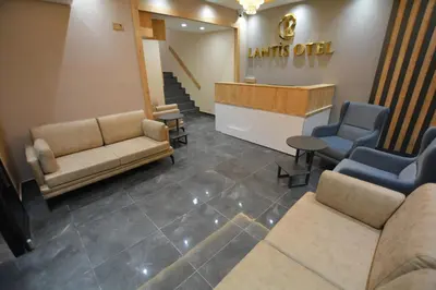 a waiting area with couches and chairs in a waiting room at Lantis Otel in Avcılar