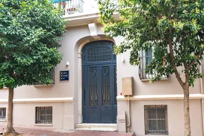 a blue door on a white building with trees at NOA - Lüleci Hendek 54 in Istanbul