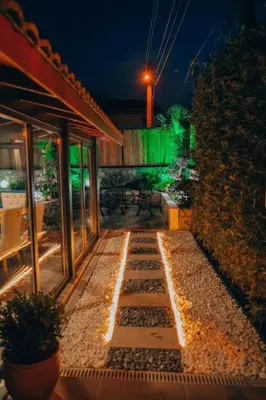a patio at night with lights on the side of a building at Çınar home in Sapanca