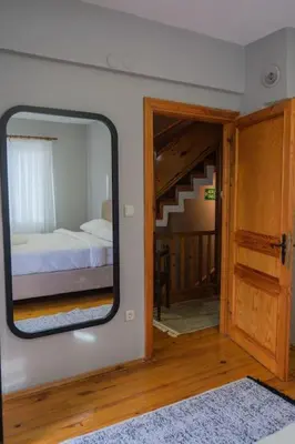 a mirror in a room with a bed and a bedroom at Çınar home in Sapanca