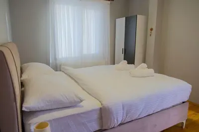 a white bed with white sheets and pillows on it at Çınar home in Sapanca