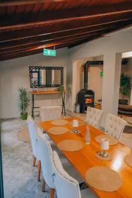 a dining room with a table and chairs and a fireplace at Çınar home in Sapanca