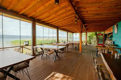 a dining room with tables and chairs and windows at Meca Deluxe Otel Sapanca in Sapanca