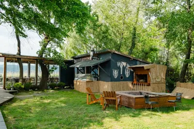 a tiny house in a yard with a table and chairs at Meca Deluxe Otel Sapanca in Sapanca