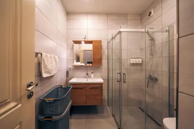 a bathroom with a sink and a glass shower at Galata Guest Teori in Istanbul