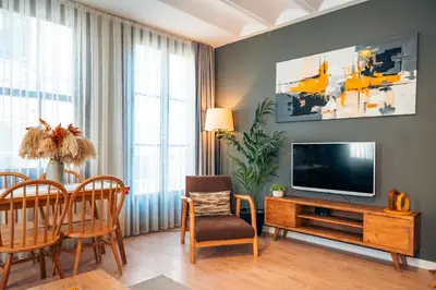 a living room with a television and a table and chairs at Galata Guest Teori in Istanbul