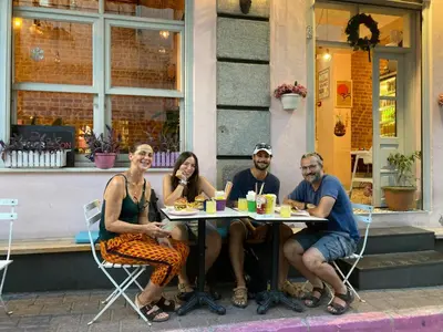 a group of people sitting at a table outside a restaurant at Balat Boutique Hotel in Istanbul