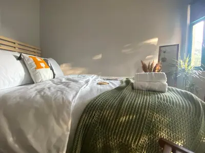 a bedroom with a bed with a green blanket on it at Balat Boutique Hotel in Istanbul