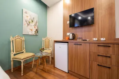 a room with a kitchen with a tv on a wall at İstanbulites Hotel in Istanbul