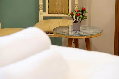 a table with a vase with flowers on it at İstanbulites Hotel in Istanbul