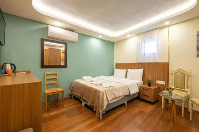 a bedroom with a bed and a table and a chair at İstanbulites Hotel in Istanbul