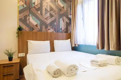a bedroom with a bed with towels on it at İstanbulites Hotel in Istanbul