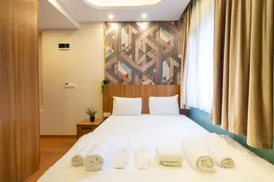 a bedroom with a bed with towels on it at İstanbulites Hotel in Istanbul