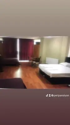 a room with a bed and a red curtain at Peri Pansiyon Butik Otel in Çınarcık