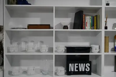 a white book shelf filled with cups and other items at Eclipse Hotel in Istanbul
