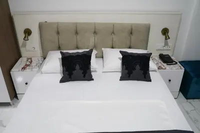 a bedroom with a white bed with black pillows at Eclipse Hotel in Istanbul