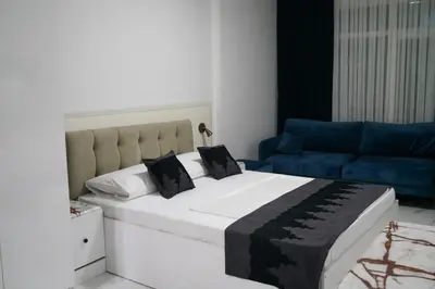 a bedroom with a large bed and a blue couch at Eclipse Hotel in Istanbul