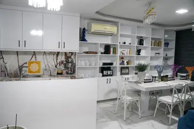a kitchen with white cabinets and a table and chairs at Eclipse Hotel in Istanbul