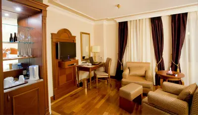 a hotel room with a desk and a room at GLK PREMIER Regency Suites & Spa in Istanbul