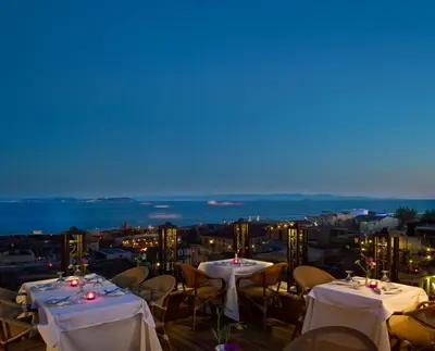 a restaurant with tables and chairs on a roof at GLK PREMIER Regency Suites & Spa in Istanbul