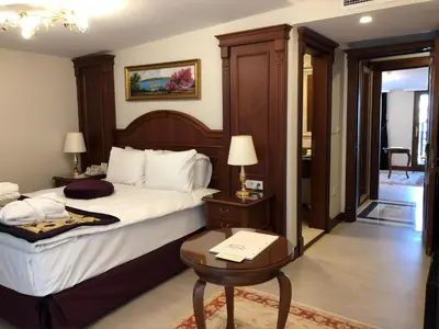 a hotel room with a bed and a table with a lamp at GLK PREMIER Regency Suites & Spa in Istanbul