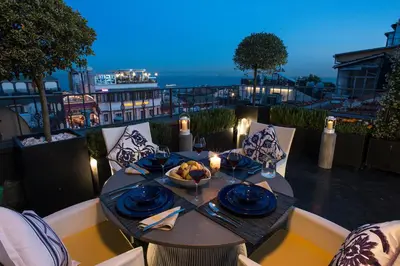 a table with a plate of food on a balcony at Istanbul Irini Seaview House in Istanbul