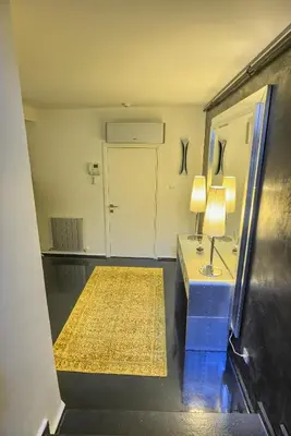 a room with a table with a lamp and a mirror at Istanbul Irini Seaview House in Istanbul