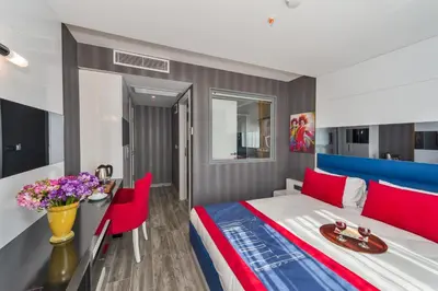 a hotel room with a bed and a table and chairs at Inntel Hotel Istanbul in Istanbul