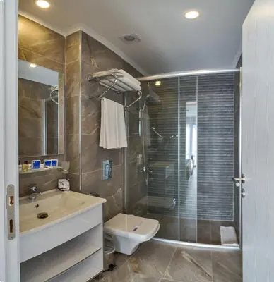 a bathroom with a sink and a toilet and a shower at Inntel Hotel Istanbul in Istanbul