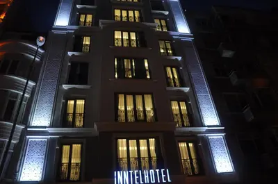 a building lit up at night with blue lights at Inntel Hotel Istanbul in Istanbul