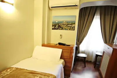 a hotel room with a bed and a window at Taksim Palace Hotel in Istanbul